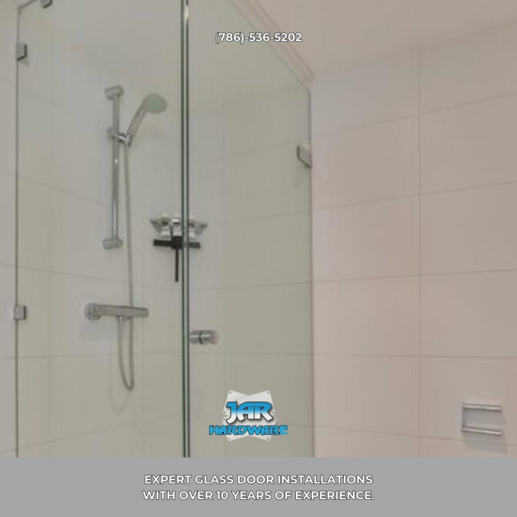 A simple and clean bathroom shower with a glass door and white tiled walls installed by Jar Hardware in Hialeah, FL.