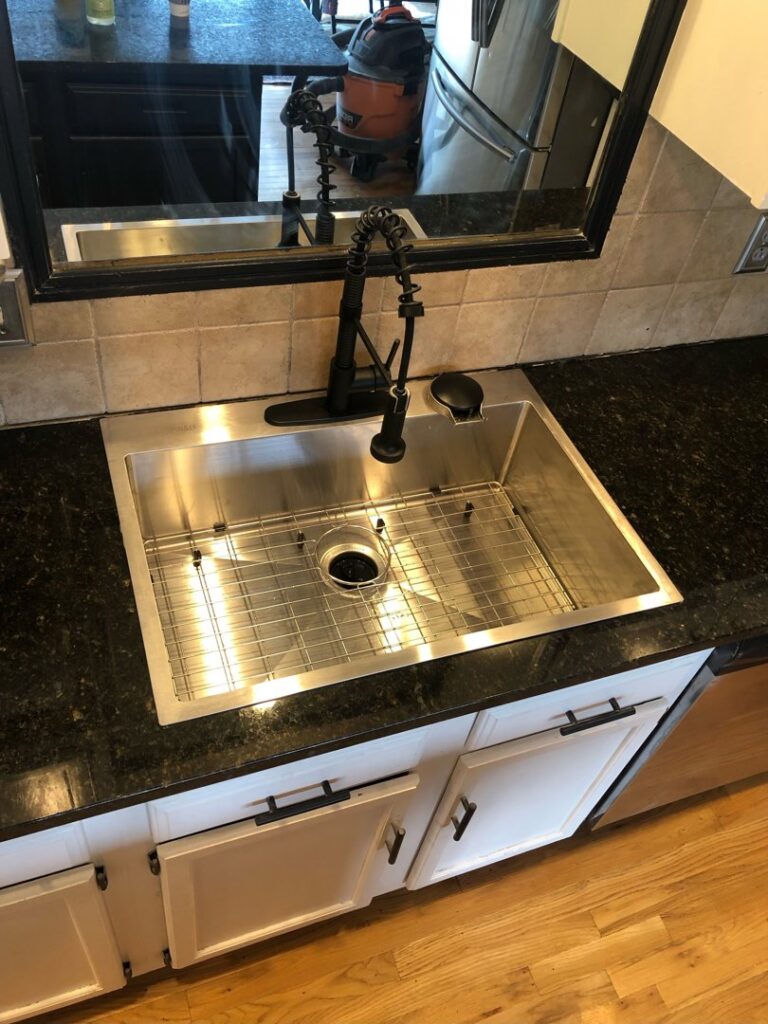 Single basin kitchen sink with new pull-down faucet installed by True North Builders in Franktown, CO.