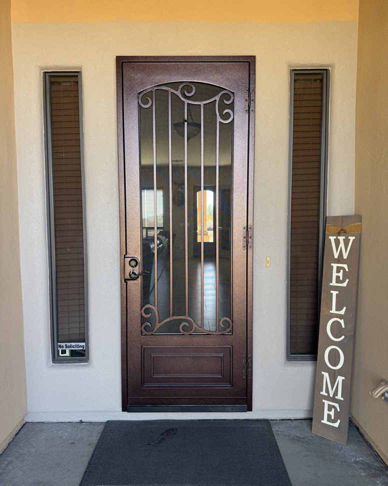 Single security screen door with a decorative scroll design installed by Steel Creations & Fabrication, INC in Glendale, AZ