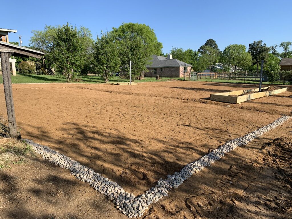 Site preparation and landscaping work, including leveled ground and raised garden beds, by Brewer Builds in Fort Worth, TX.