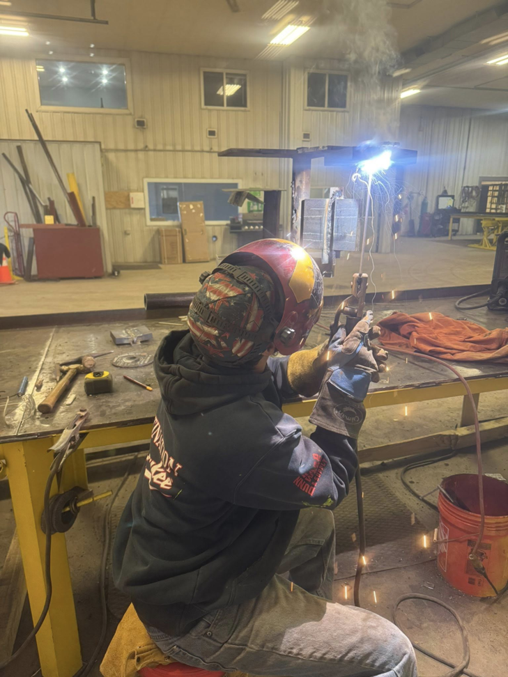 A skilled welder performing metal fabrication work for Siva Steel LLC in Saginaw, MI.
