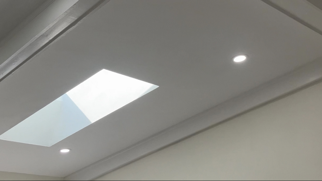 A modern ceiling featuring a new skylight and recessed lighting installed by Precision Home Improvement in Virginia Beach, VA.