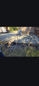 Slab lifting jacks installed next to a concrete patio by Gulf Coast Foundation Solutions in Lafayette, LA