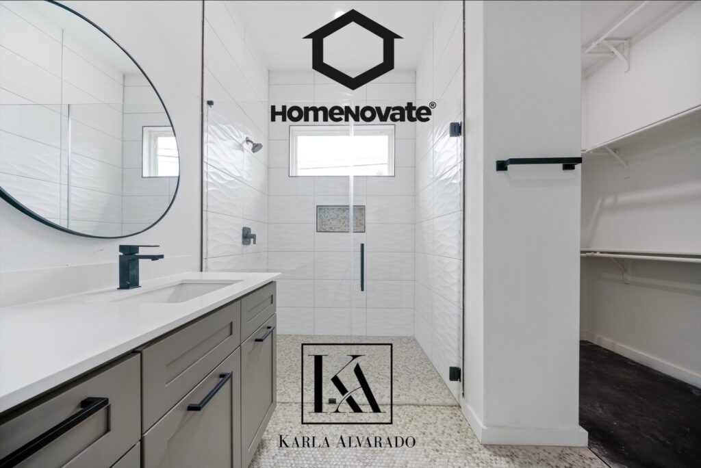 A sleek, modern bathroom remodel featuring a single vanity and glass shower by HomeNovate in San Antonio, TX.