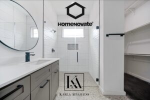 A sleek, modern bathroom remodel featuring a single vanity and glass shower by HomeNovate in San Antonio, TX.