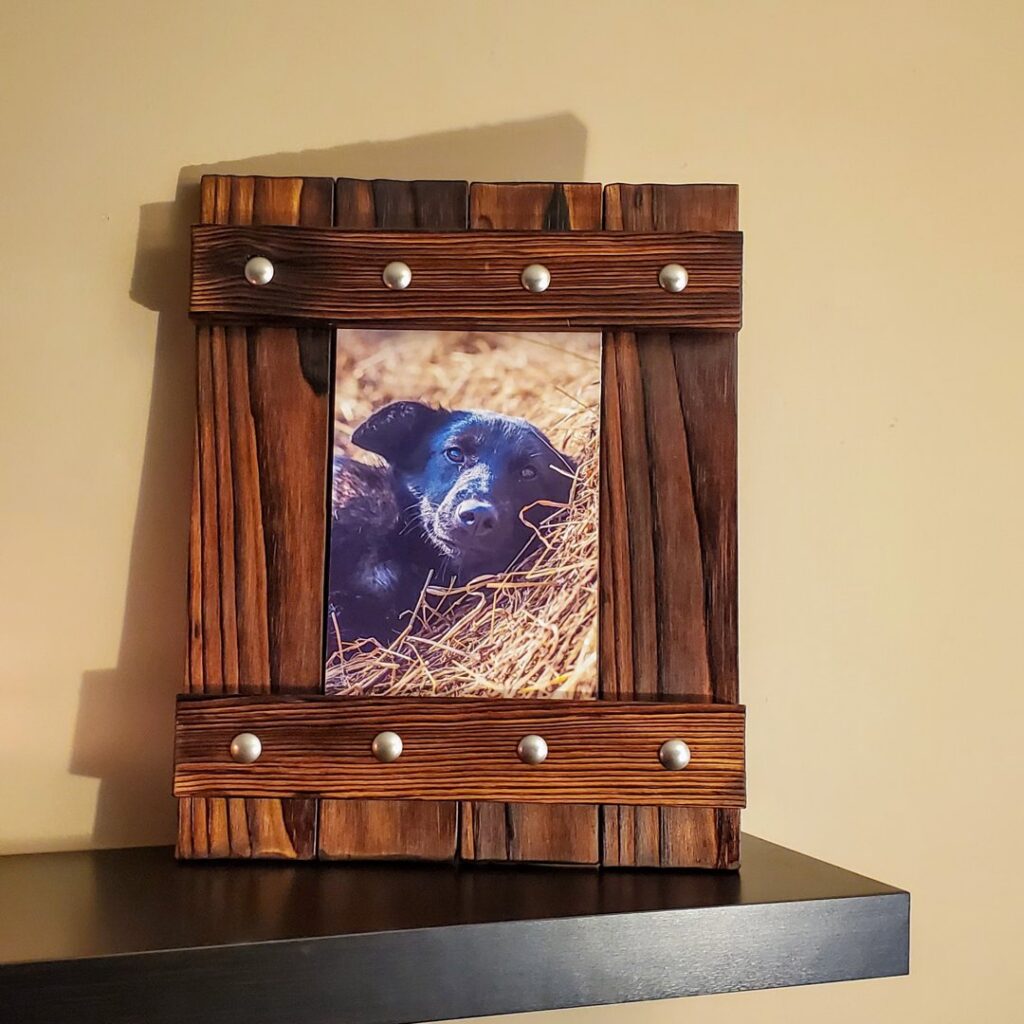 A white sliding barn door with black hardware professionally installed by Dovetails Services LLC in Derry, NH.
