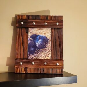 A white sliding barn door with black hardware professionally installed by Dovetails Services LLC in Derry, NH.
