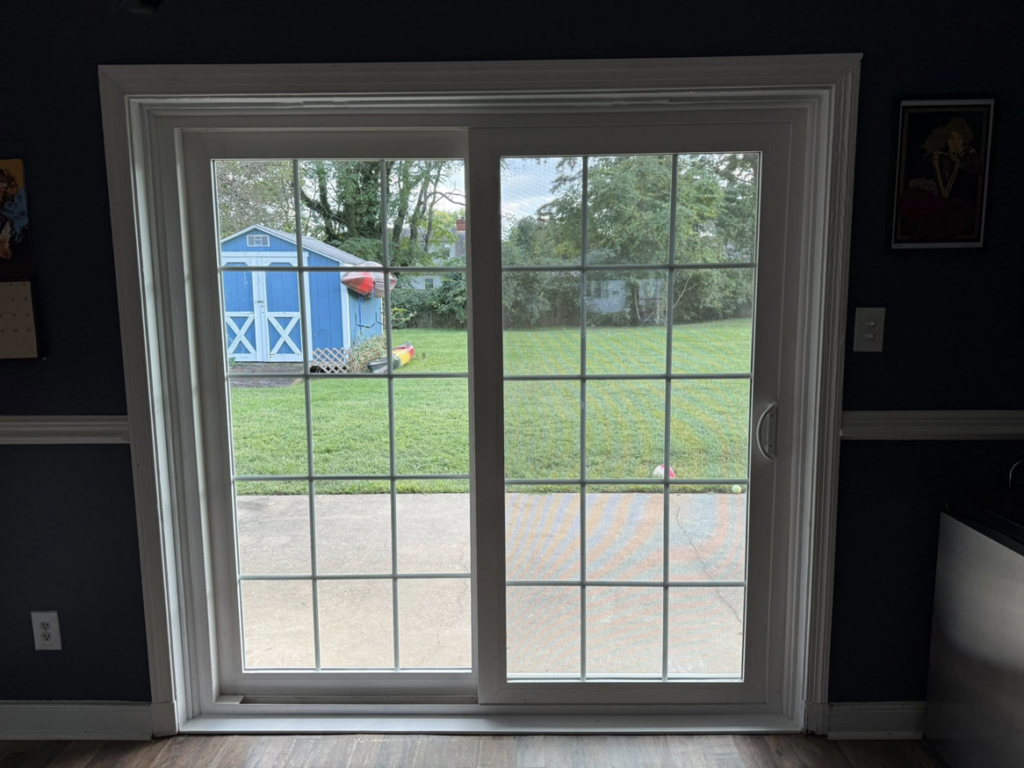 Interior view of a newly installed sliding patio door with grids, a service provided by CNG Contracting Group in Richmond, VA