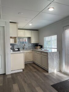 A small kitchen renovation with light cabinets and a marble-look countertop by Stone Age Granite of Austin, TX.