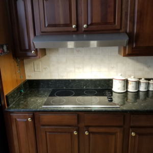 A modern smooth-top electric cooktop installed in a kitchen, demonstrating services from Paul's Handyman Solutions in Lexington, KY.