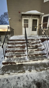 Snow-covered stairs and walkway needing clearing by Build Brothers in Providence, RI