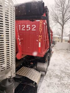 A Geppert Recycling truck providing dumpster service in a snowy residential area of Philadelphia, PA.