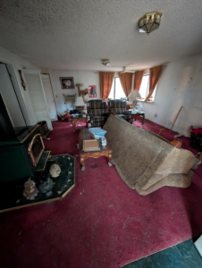 A living room with an old sofa and other furniture, ready for removal by Patriot Hauling & Junk Removal LLC in Salem, OR.