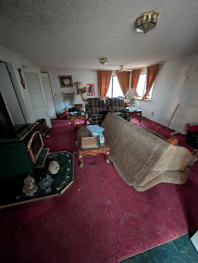 A living room with an old sofa and other furniture, ready for removal by Patriot Hauling & Junk Removal LLC in Salem, OR.