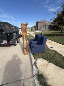 A blue sofa loaded into the back of a City to City Junk Removal Fort Worth, TX pickup truck for furniture removal.