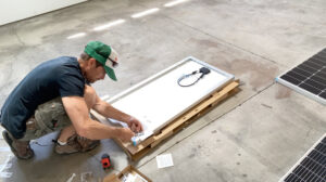 A handyman assembling solar panels for installation by Top Shelf Handyman Pros in Post Falls, ID