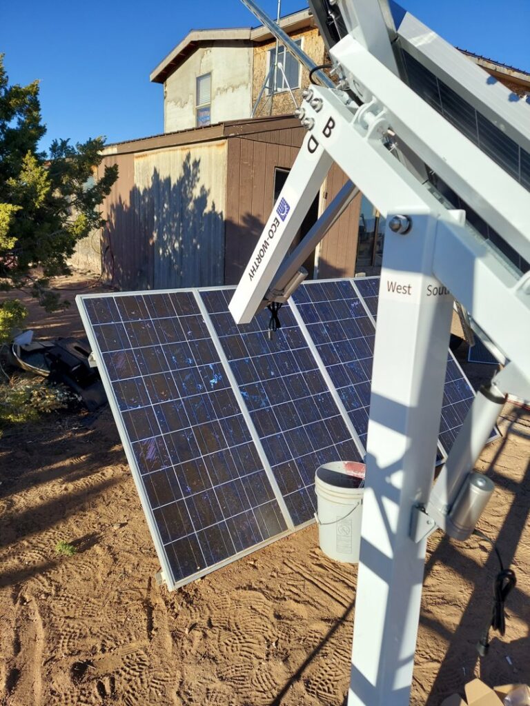 Outdoor solar panels being installed or repaired by Handyman Services of Albuquerque in Albuquerque, NM, with a house in the background.