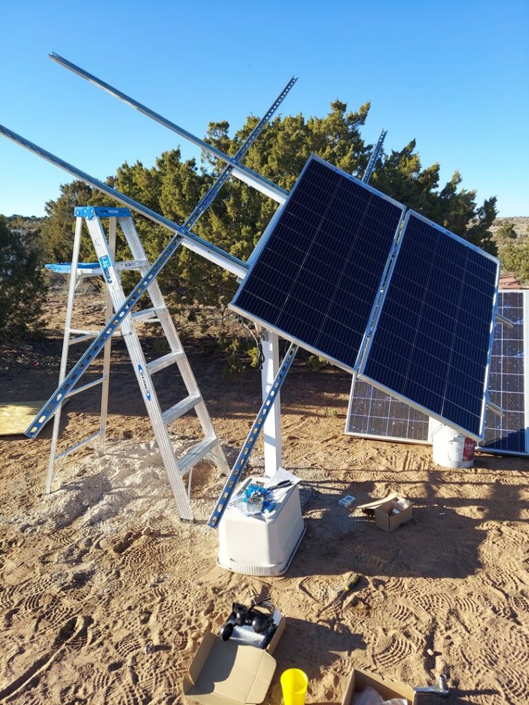 A handyman installing or repairing solar panels outdoors with a ladder, provided by Handyman Services of Albuquerque in Albuquerque, NM.