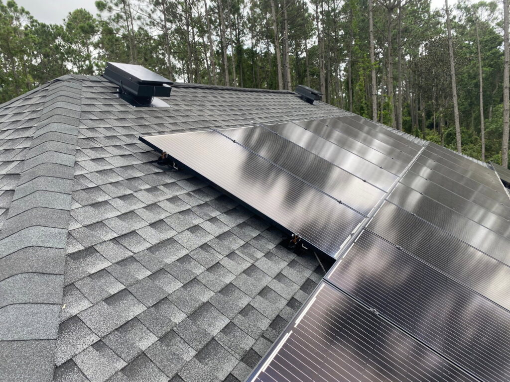 Solar panels and a solar attic fan installed on a residential roof by Koala Insulation of Charlotte, NC