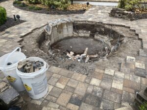 Spa demolition and excavation in progress, showing exposed pipes and debris, handled by JJB Pools & Spas in Tampa, FL.