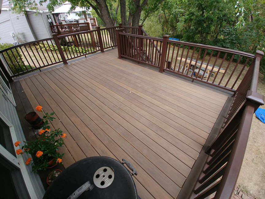 A spacious, finished outdoor deck surface with railings, built by Custom Remodeling Inc. in Houston, TX.