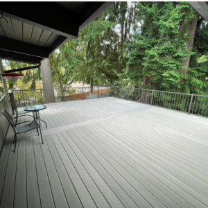 A spacious finished outdoor deck with modern metal railings and seating, completed by Kalau Builders LLC in Eugene, OR.