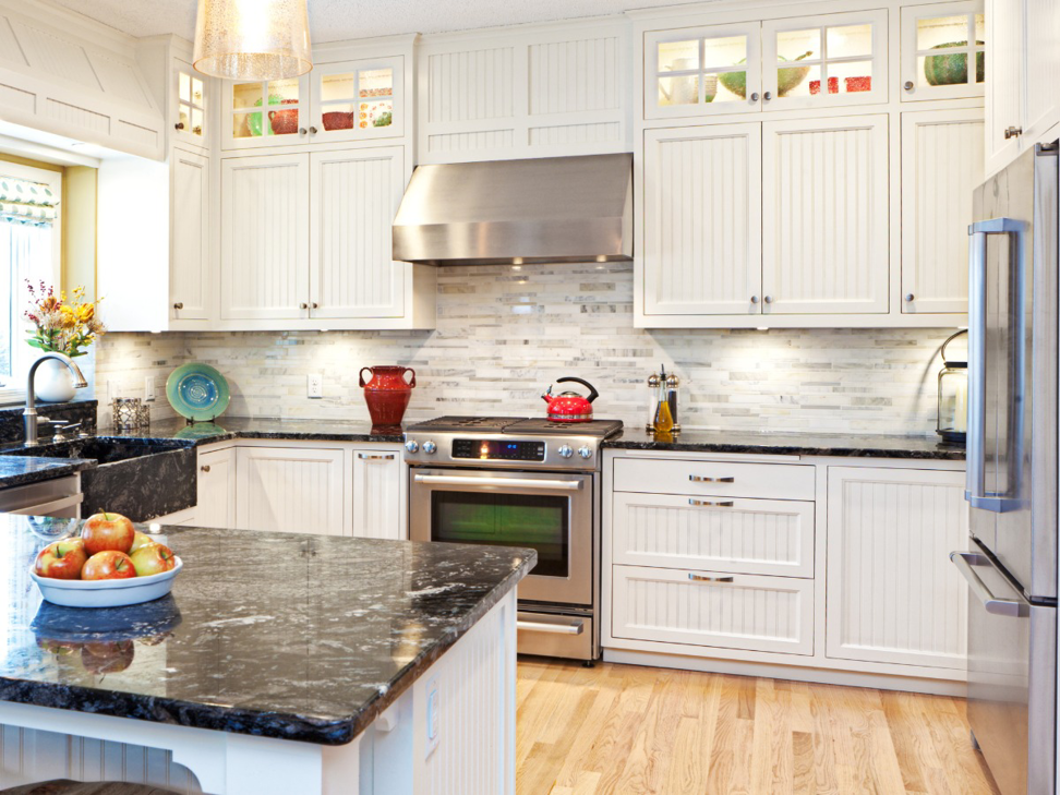 A spacious kitchen remodel featuring white cabinets, dark granite countertops, and a large island by FEARS Construction in Nashville, TN.