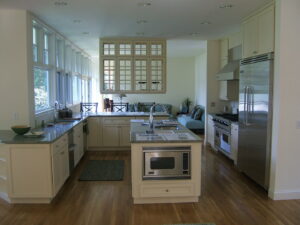 A spacious, newly renovated kitchen with light cabinets, a central island, and stainless steel appliances by Santoro Home Improvements in Wallingford, CT.