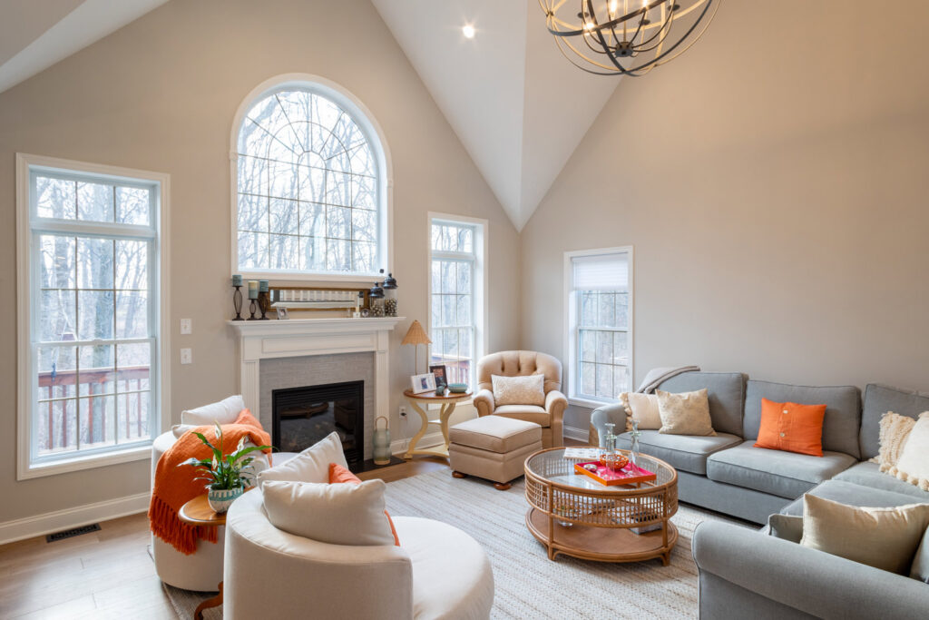 A spacious living room remodel with high ceilings, a modern fireplace, and large windows by Pluff Contractors LLC in Lancaster, PA.
