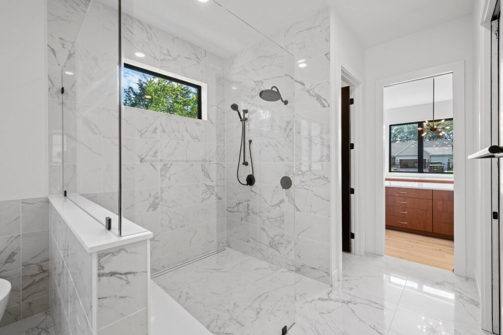 Spacious modern bathroom remodel with walk-in shower by Thermal Concepts, Inc in St. Louis, MO.