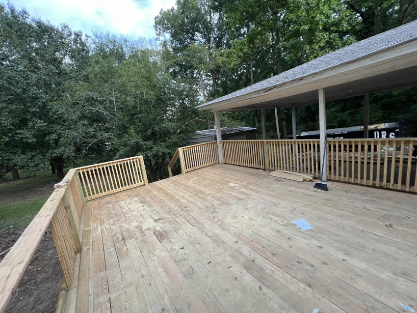A spacious new wooden deck with sturdy railings, expertly built by JD Handyman service LLC in Miami, FL.
