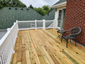 Spacious outdoor deck installation with white railings and sliding door by SG Service, LLC in Lincoln, NE