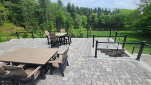 A spacious outdoor paver patio with comfortable furniture and cable railings installed by David Hayden Construction LLC in Danbury, CT.