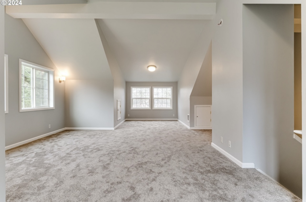 A spacious remodeled bonus room with new carpet and light fixtures by Green Peaks Painting and Remodeling in Elmira, OR