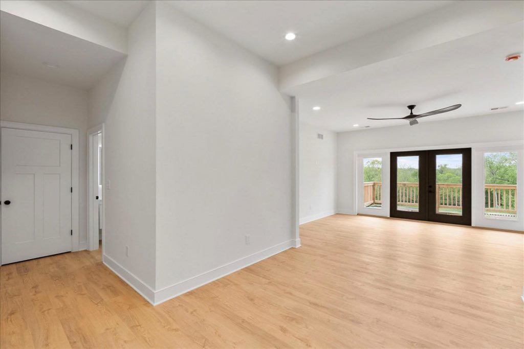 Spacious room with light hardwood floors expertly installed or refinished by WoodHaven Floor Refinishing in Georgetown, KY.