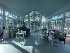 The interior of a spacious sunroom with large windows by Four Seasons of River City in Columbus, GA.