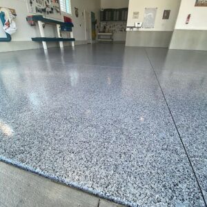 A close-up view of a durable speckled epoxy garage floor installed by Painting Pros of Knoxville in Knoxville, TN.