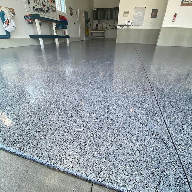 A close-up view of a durable speckled epoxy garage floor installed by Painting Pros of Knoxville in Knoxville, TN.