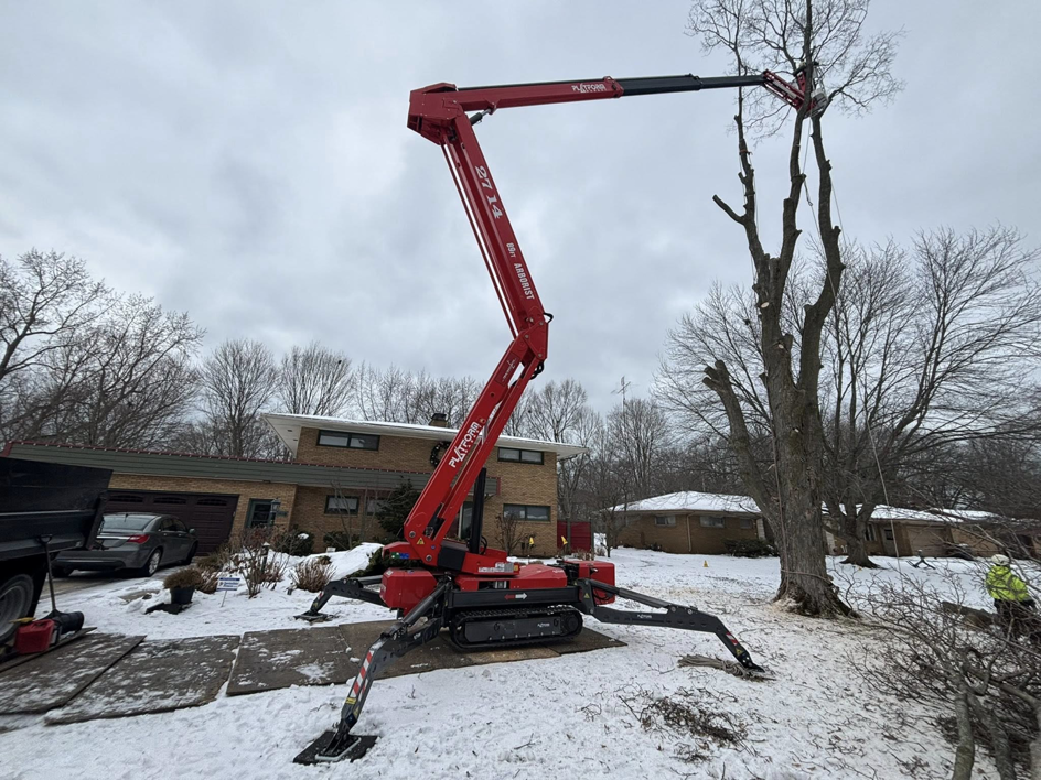 A red spider lift extended for tree trimming and removal by Valera Tree Services in Benton Harbor, MI.