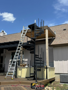 J8 General Construction installing a new spiral staircase on a residential deck in San Antonio, TX.