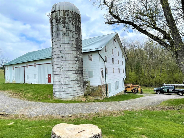 A Spoutco Home Improvements truck and equipment parked at a barn and silo job site in York, PA.