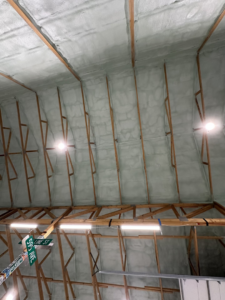 Spray foam insulation applied to the ceiling of a large structure by Tumbarello Insulation in Peyton, CO.