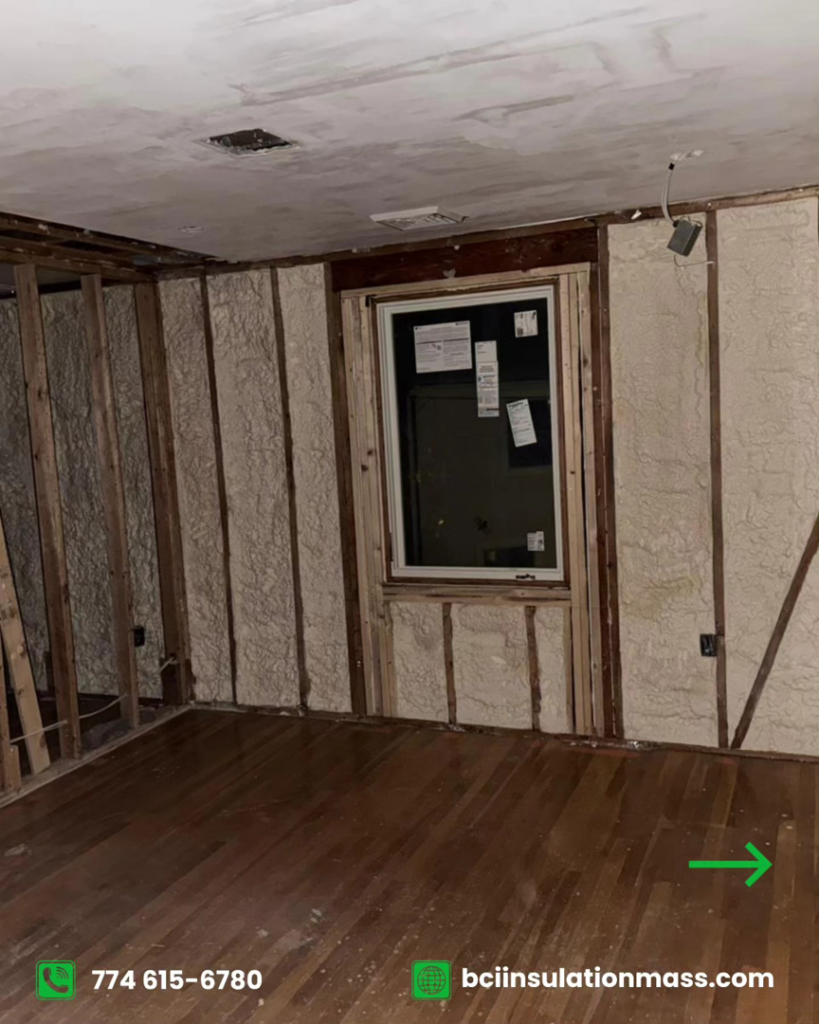 Spray foam insulation being installed on wall studs in a room under renovation by BCI Insulation in Byron, GA