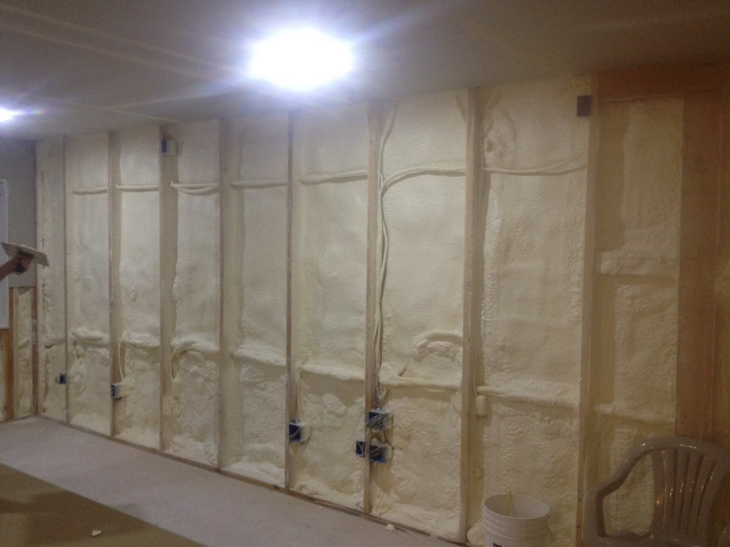 Spray foam insulation being installed between wall studs by Kwik Insulation in Spokane, WA.