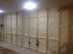 Spray foam insulation being installed between wall studs by Kwik Insulation in Spokane, WA.