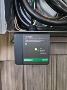 A Square D surge protective device installed within an electrical box by MorLite Electric in Newport News, VA.