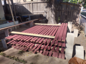 A large stack of pre-finished wood boards ready for a deck project by Do-N-All Handyman Service in Wichita, KS.