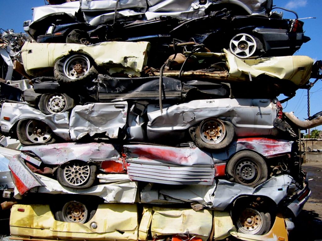 A large stack of crushed cars ready for recycling at SA Recycling - Long Beach Ave in Los Angeles, CA.