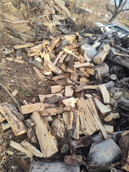 Stacked logs after tree clearing services by Hoffman Construction Services, LLC in Saint Joseph, MO.