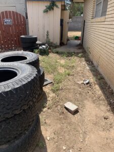 Stacked tires in a side yard, ready for removal by Roadrunner JunkSmart Solutions LLC in Las Cruces, NM.